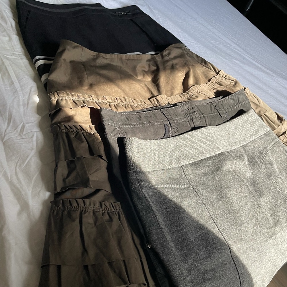 White House Black Market.  4 skirts . Size 2.